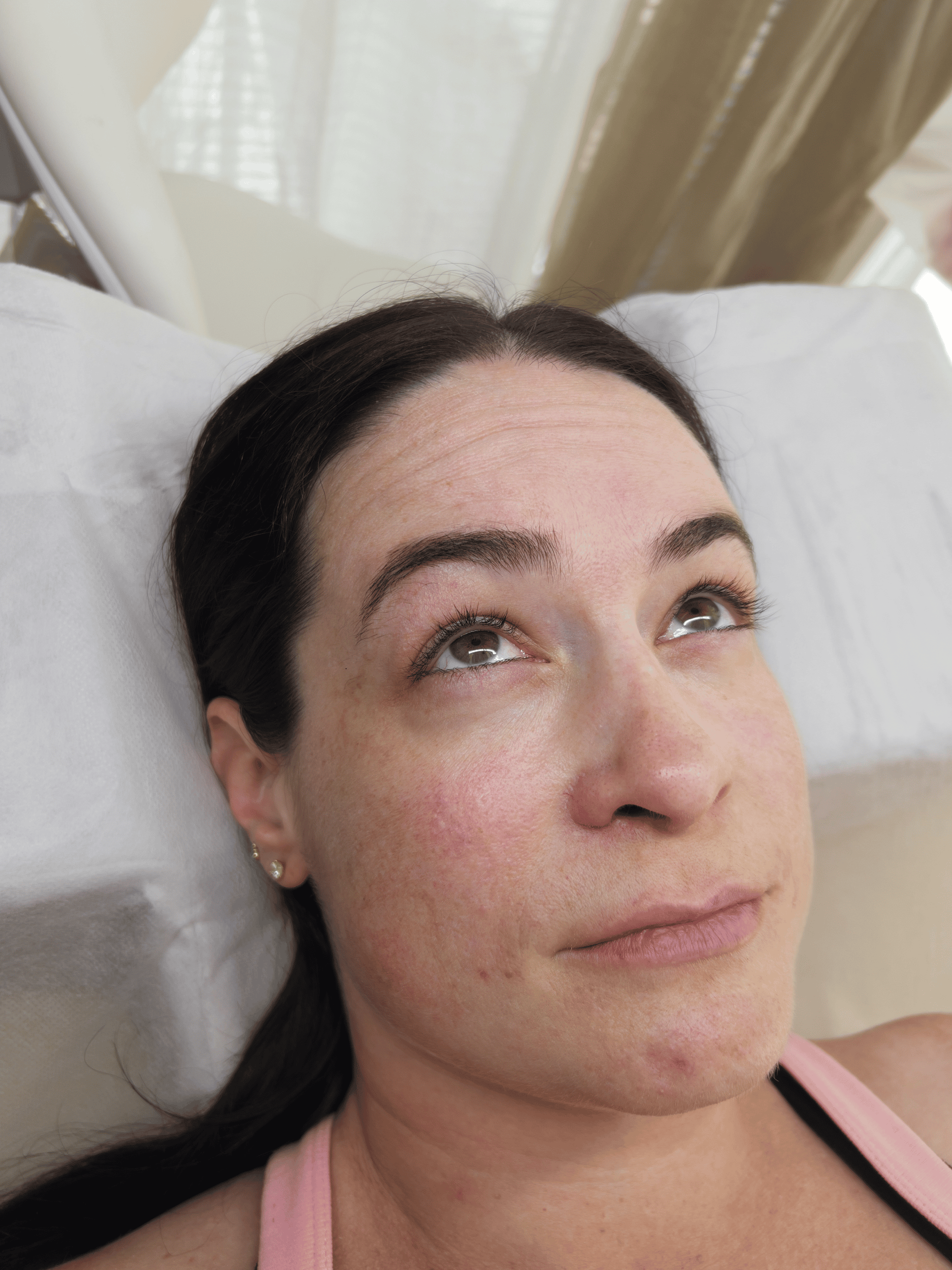 The same eye after a Korean lash lift and tint, lifted at the base and darker
