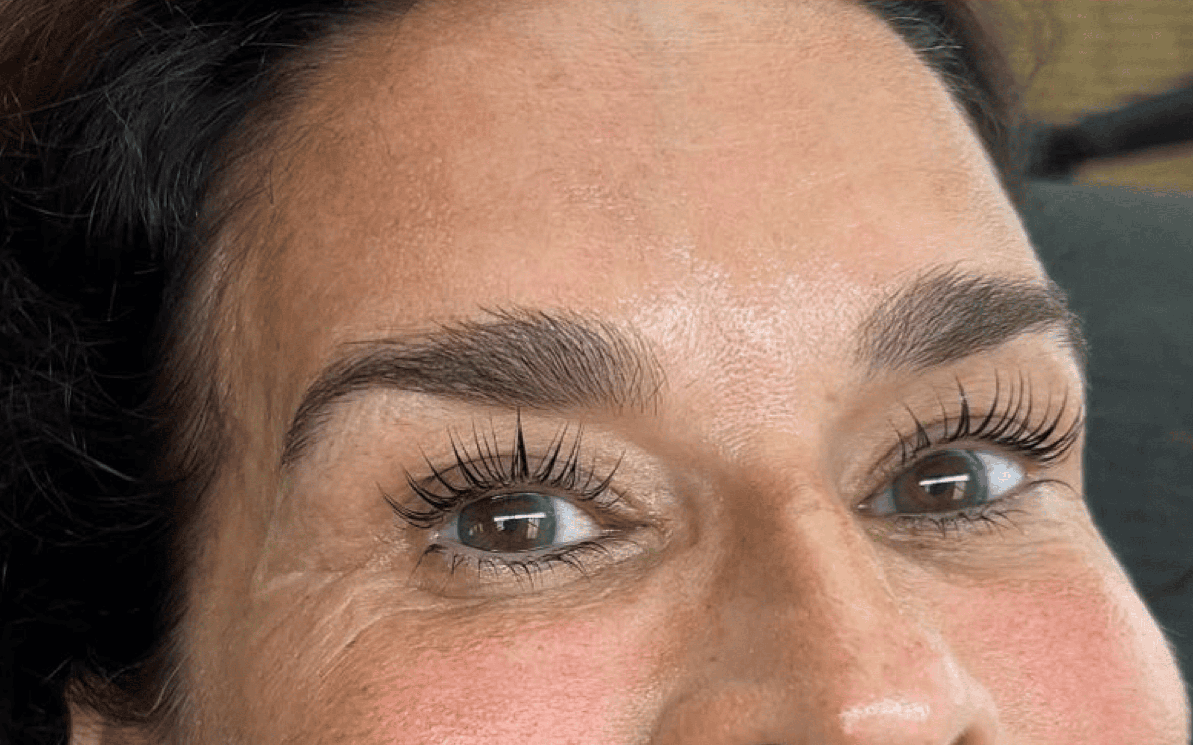 The same eye after a Korean lash lift and tint, lifted at the base and darker