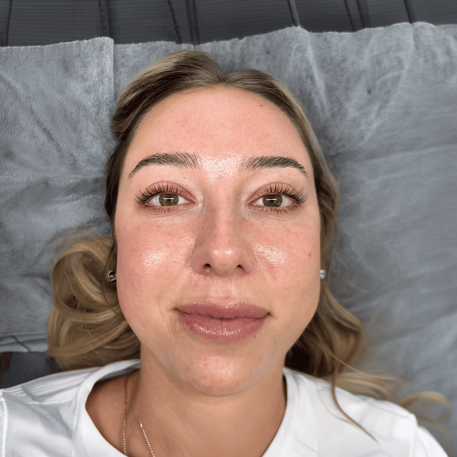 The same eye after a Korean lash lift and tint, lifted at the base and darker